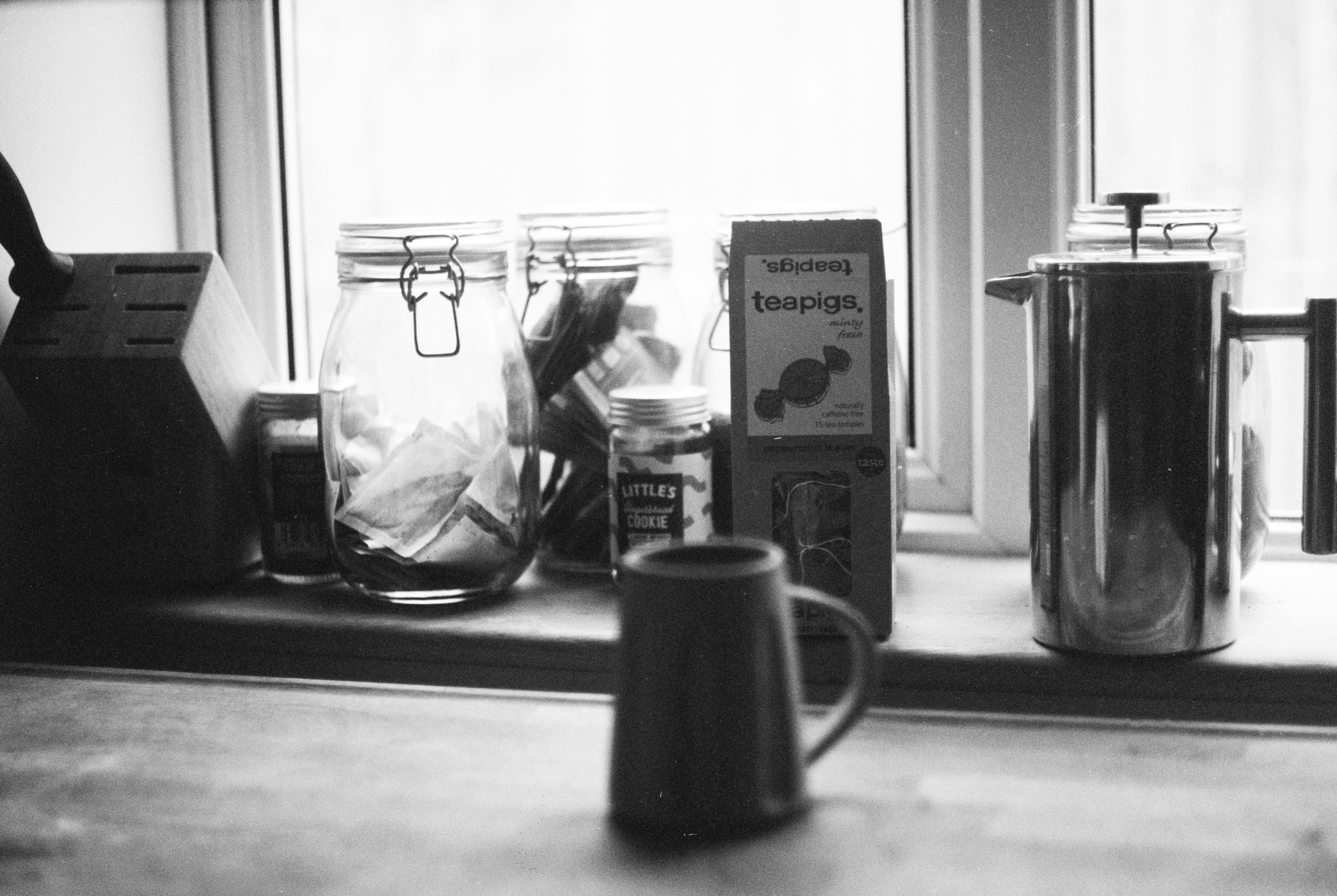 grayscale photo of ceramic mug beside the box